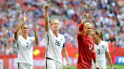 USA players salute the crowd after victory over Nigeria guaranteed progression as Group D winners. Rich Lam / Getty / June 16, 2015