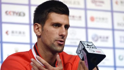 Novak Djokovic talks to the media ahead of the China Open. Goh Chai Hin / AFP