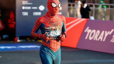 A runner wearing a spider man costume takes part in the 2020 Shanghai marathon. AFP