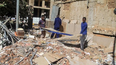 Construction workers remove debris in Khartoum, Sudan, as efforts to restore the city’s infrastructure resume. Getty