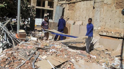 Construction workers remove debris in Khartoum, Sudan, as efforts to restore the city’s infrastructure resume. Getty