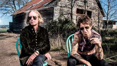 Arthur Buck is Peter Buck (left) and Joseph Arthur. (Dean Karr/New West Records via AP)