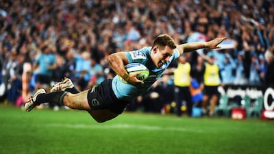 New South Wales Waratah's flyhalf Bernard Foley dives over to score the clinching try against the ACT Brumbies in their Super Rugby semi-final rugby match at Sydney on July 26, 2014. William West / AFP