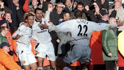 Forlan, left, celebrates with teammates Ryan Giggs and John O’Shea after scoring the Frist of his two goals against Liverpool during their Premier League clash at Anfield on 1 December 2002. Paul Barker / AFP