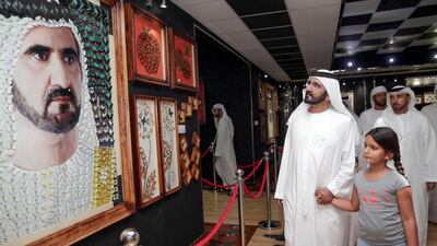 The Ruler of Dubai admires the artwork at the Dubai Butterfly Garden.