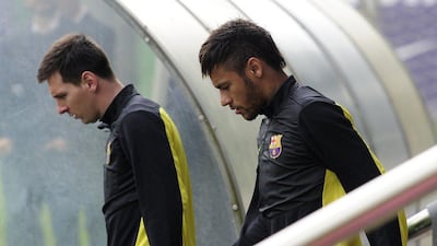 FC Barcelona forwards Lionel Messi and Neymar arrive at a training session on Monday for Barca's Champions League quarter-final first leg against Atletico Madrid on Tuesday. Josep Lago / AFP / March 31, 2014