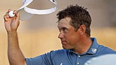 Westwood acknowledges the 18th hole gallery after winning the Dubai World Championship.