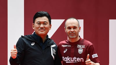 Andres Iniesta and Hiroshi Mikitani, owner of Rakuten and Vissel Kobe club, pose for pictures on the pitch of Noevir Stadium in Kobe, Japan. Martin Bureau / AFP