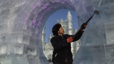 A Chinese labourer uses a tool to shave large ice blocks in preparation for the Harbin Ice and Snow Festival in Harbin, China. Getty Images