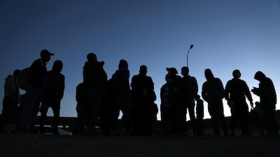 Palestinian workers from the West Bank city of Hebron carry belongings as they cross the checkpoint of Mitar on their way to work in Israel. EPA