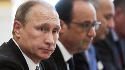 Russian president Vladimir Putin, left, and French president Francois Hollande, centre, attend a meeting with German chancellor Angela Merkel and Ukrainian president Petro Poroshenko at the Elysee Palace in Paris on October 2, 2015. Etienne Laurent/Pool Photo Via AP