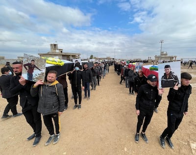 Mourners carry coffins of Yazidis from the village of Kocho, who were killed by ISIS in August 2014. Their remains were exhumed from mass graves and buried near the village. Reuters
