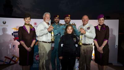 Chaica Al Qassimi with the Guardians of the Flame and the World Games Flame of Hope. Courtesy Etihad