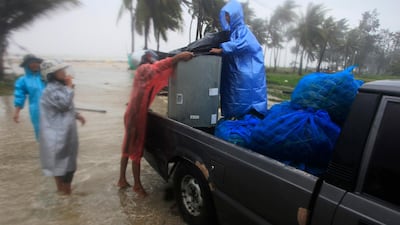 Locals clear out supplies from the coastline in preparation for the approaching Tropical Storm Pabuk, in Pak Phanang, in the southern province of Nakhon Si Thammarat, southern Thailand. AP Photo