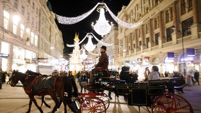 A carriage drives through an illuminated street in the city centre of Vienna, Austria. AFP