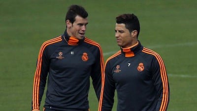 Cristiano Ronaldo talking with Gareth Bale at Tuesday's Real Madrid training session. Sergio Perez / Reuters / April 1, 2014