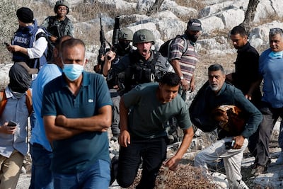 An Israeli soldier shouts at Palestinian protesters who were praying on their land, which is threatened by Israeli settlement expansion, in Beit Lid, near Tulkarm, in the Israeli-occupied West Bank. Reuters