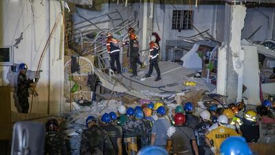 Rescuers search for survivors trapped in the debris. Getty