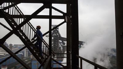 A worker walks in a tower overlooking part of the Zhong Tian (Zenith) Steel Group Corporation. Kevin Frayer / Getty Images