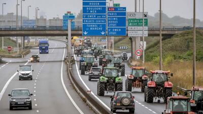 Truck drivers and farmers drive from Loon Plage to Calais on September 5, 2016, during a joint "go-slow" protest on the A16 highway calling for the dismantling of the migrant camp in the French northern port city of Calais, commonly called "Jungle". Philippe Huguen/AFP