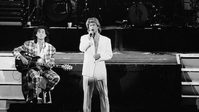 In this April 7, 1985 file photo, George Michael and Andrew Ridgeley perform during a concert in Beijing – the first western pop show in communist China. AP Photo