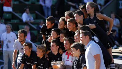 Stan Wawrinka of Switzerland poses with ball boys after beating Novak Djokovic of Serbia during the men’s final match for the French Open tennis tournament at Roland Garros in Paris, France, 07 June 2015. EPA/ROBERT GHEMENT