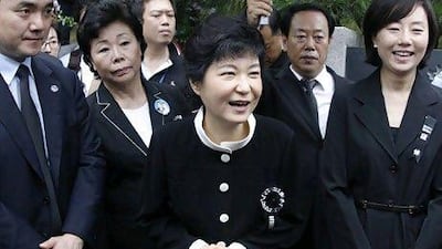 Park Geun-hye, centre, greets people after a memorial service for her mother and the late first lady Yuk Young-soo at the national cemetery in Seoul on August 15, 2012. Lee Jae-Won / Reuters