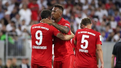 Bayern's Robert Lewandowski, back to camera on left, celebrates with defender Jerome Boateng after scoring. Reuters