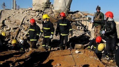 Fire fighters look for survivors at the local headquarters of the Kurdistan Democratic Party after a bomb attack in Kirkuk.