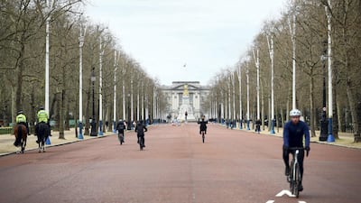 Cyclists ride along The Mall in front of Buckingham Palace in London. Reuters