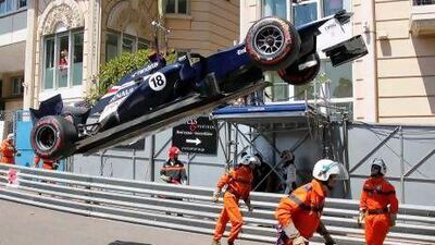 Safety engineers oversee the removal of Pastor Maldonado's Williams car from the track in Monte Carlo. Robert Pratta / Reuters