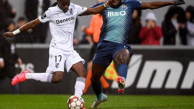 Vitoria de Guimaraes' Sacko, left, fights for the ball with Porto's Moussa Marega. EPA