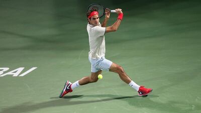 Roger Federer of Switzerland returns back-handed to Radek Stepanek of Czech Republic in the second round of the Dubai Duty Free Tennis Championships on Wednesday, 26 February 2014. Ali Haider / EPA