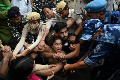 Indian wrestler Vinesh Phogat is detained by police along with other wrestlers while attempting to march to India's new parliament in May. AFP