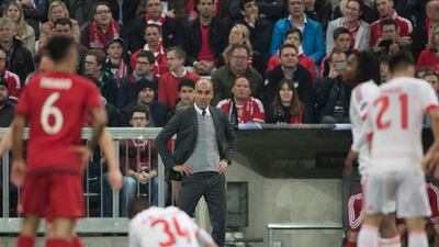Bayern Munich coach Pep Guardiola, centre, looks on from the sidelines during the Uefa Champions League quarter-final, first-leg football match against Benfica Lisbon in Munich, southern Germany, on April 5, 2016. / AFP / ODD ANDERSEN