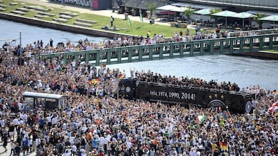 Fans throng a street along the river Spree in central Berlin to cheer the team. Steffi Loos / Reuters