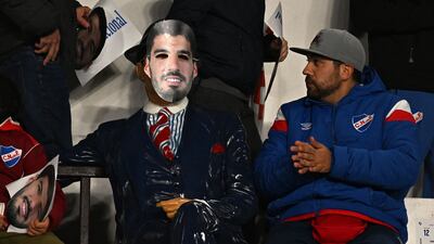 Nacional fans with Luis Suarez posters and masks. AFP