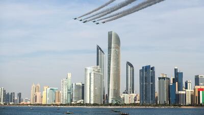 The Al Fursan aerobatic team light up the skyline of Abu Dhabi. Khushnum Bhandari / The National