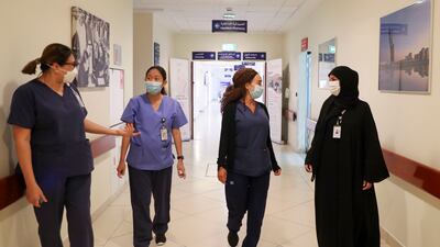 Arwa Salem Al Menhali, far right, assistant director of nursing, with, left to right, charge nurse Tan Cheng Nee, staff nurse Yvette Prieto and senior charge nurse Ramza El Chaer at Corniche Hospital, Abu Dhabi. Khushnum Bhandari / The National