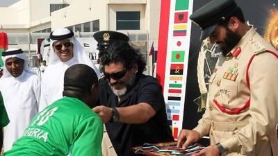 Diego Maradona presents medals to the Nigerian team members during the closing ceremony of the 'World Cup for the inmates' at the Dubai Central Prison in Al Aweer.