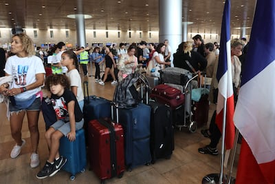 Foreign citizens leaving Israel check in at Ben Gurion International Airport amid the ongoing battles between Israel and Hamas. Israel's tourism sector is expected to be affected in the short term. AFP