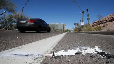 A vehicle goes by the scene of Sunday's fatality, where a pedestrian was stuck by an Uber vehicle in autonomous mode, in Tempe, Arizona. AP