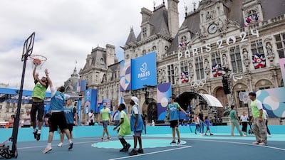 People play basketball in front of the Hotel de Ville. Getty Images