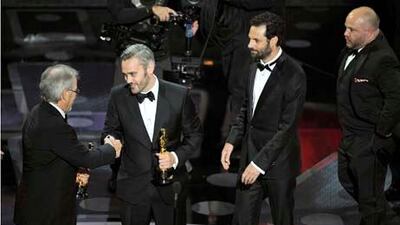 Steven Spielberg presents Iain Canning, Emile Sherman and Gareth Unwin their Oscars for best motion picture for The King's Speech at the 83rd Academy Awards.