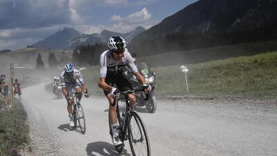 Great Britain's Christopher Froome, centre, rides in the ascent of the Plateau des Glieres during the 10th stage of the Tour de France between Annecy and Le Grand-Bornand. Jeff Pachoud / AFP