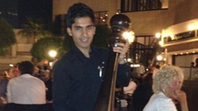 Ashan, a Boccaccio waiter, poses with the restaurant's one-metre pepper grinder.