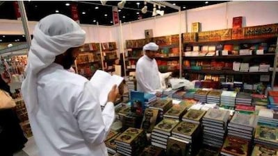 Men look at books displayed at the Abu Dhabi International Book Fair last year. Karim Sahib / AFP