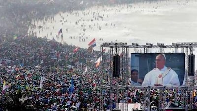 Pilgrims listen to the mass celebrated by Pope Francis at the closure of the 28th World Youth Day at Copacabana beach, Rio de Janeiro.