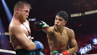 Canelo Alvarez evades a punch thrown by Jaime Munguia. AFP
