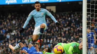 Manchester City's Jesus, center, jumps over Pickford. AP Photo